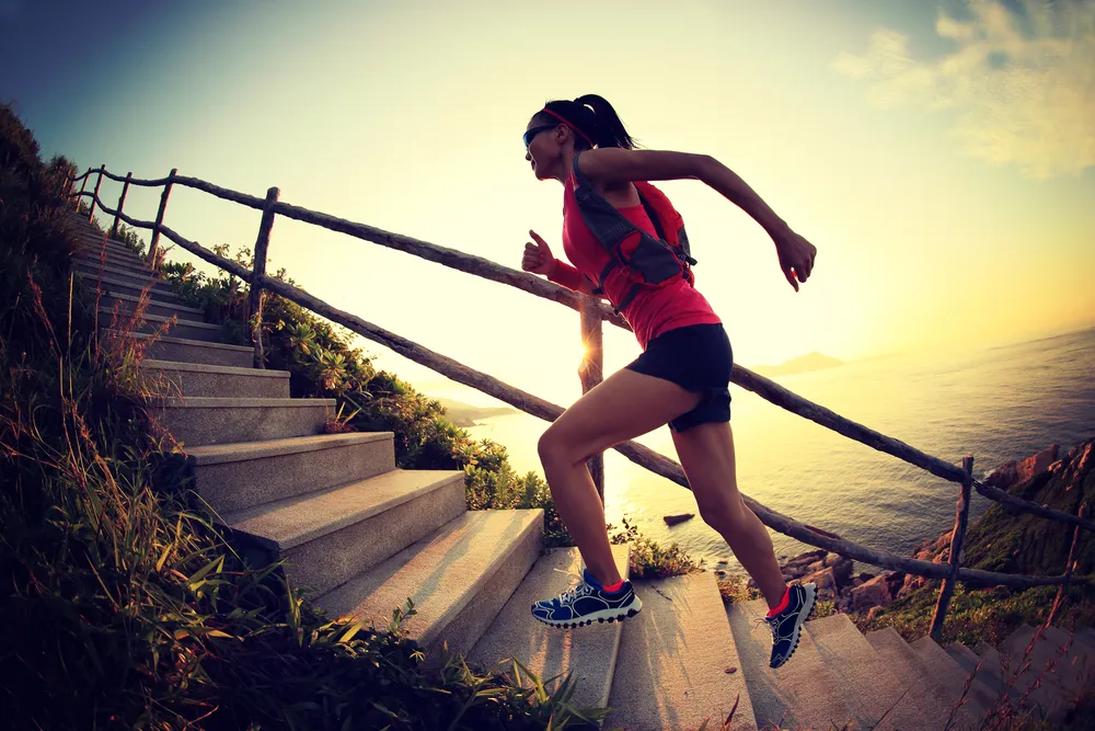 A girl runs up the stairs high in the mountains